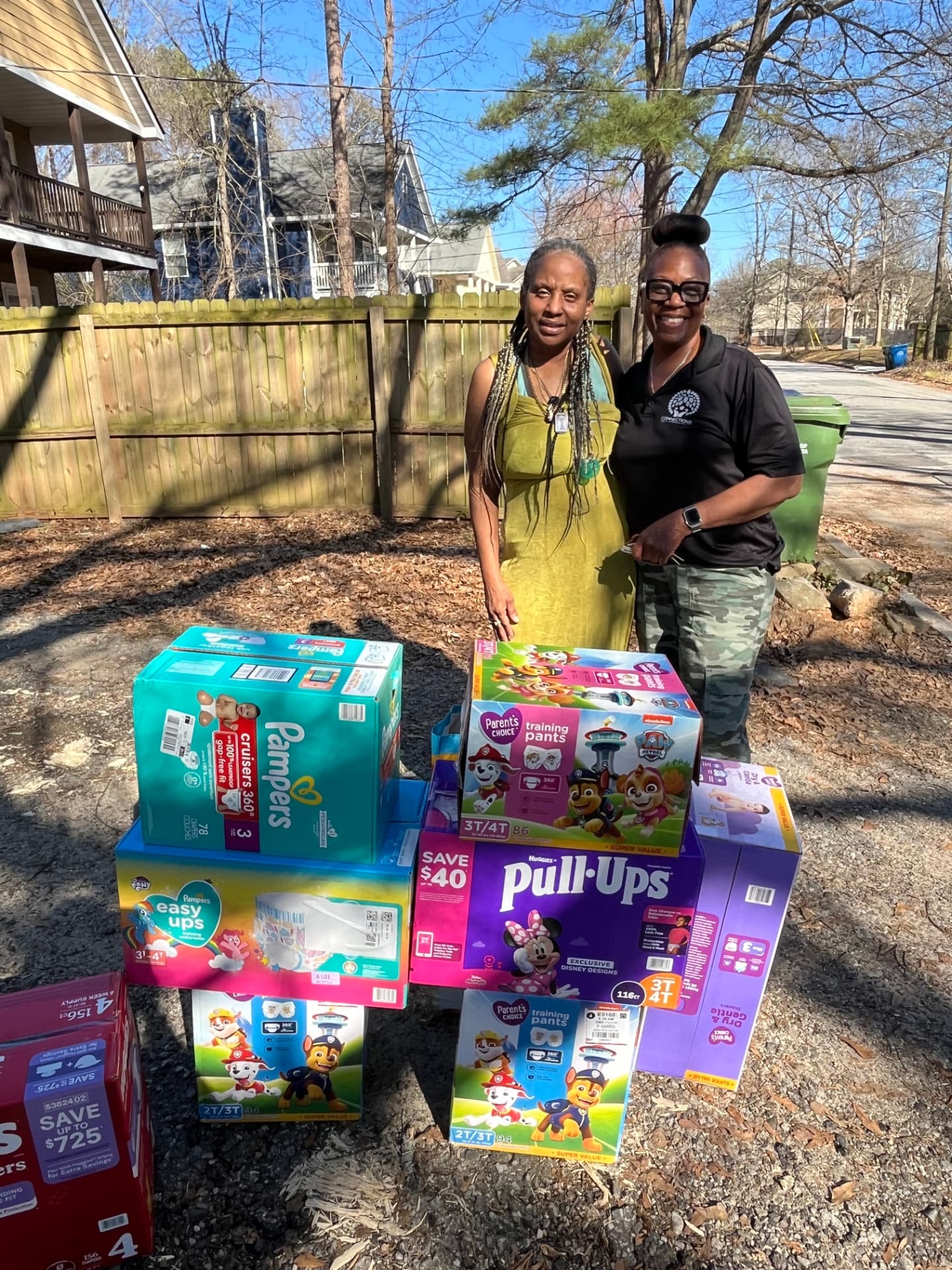 Connections team member delivering boxes of diapers and essential supplies